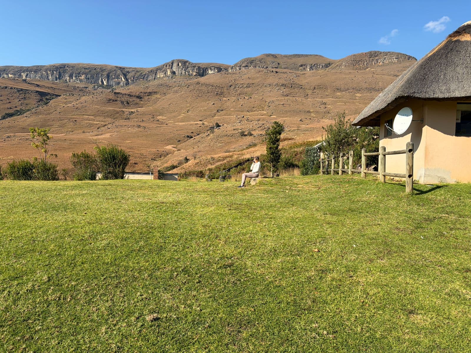 Thatched lodge with Drakensberg mountains
